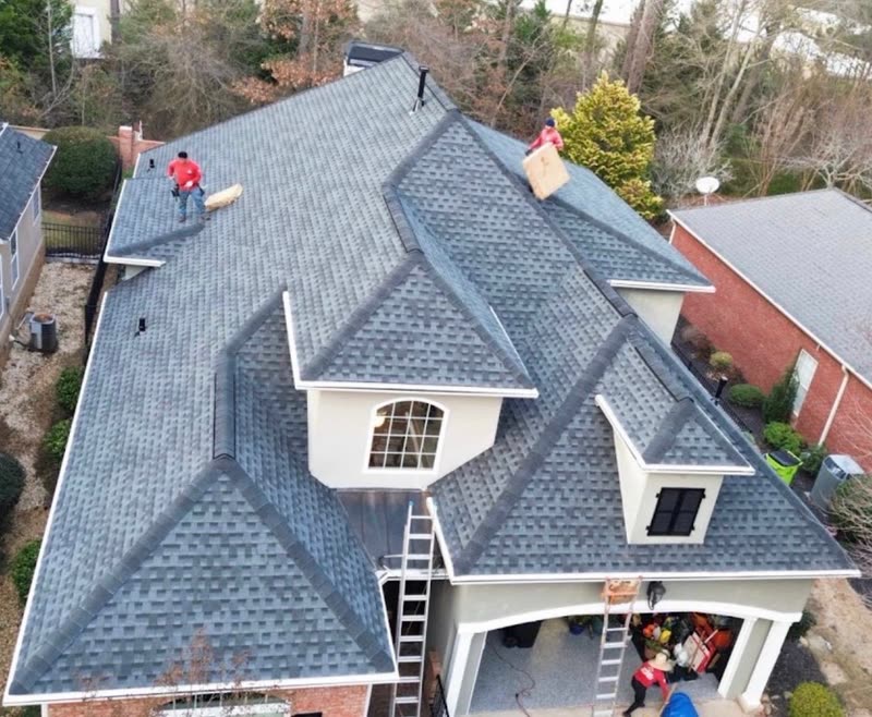 Finished shingle roof over the gables and dormers of a stucco and brick home