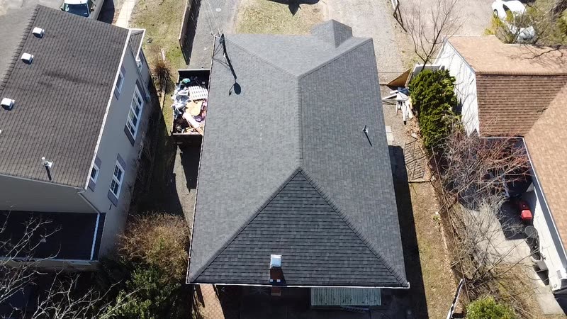 Overhead view of a finished hip roof in new architectural shingle