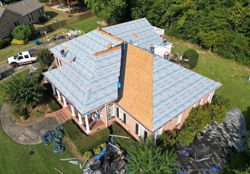 Roof half stripped to decking and half covered in underlayment during a replacement