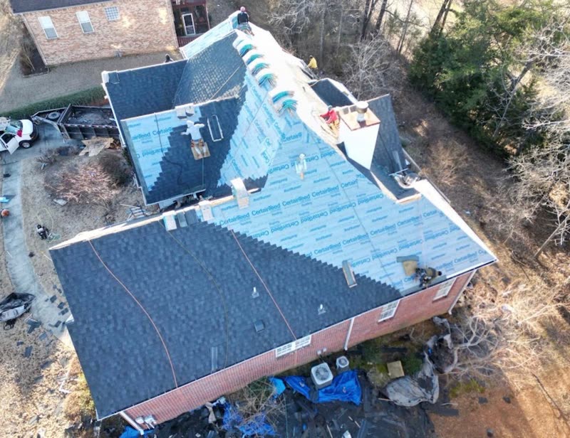 New shingles going on over synthetic underlayment on a brick home