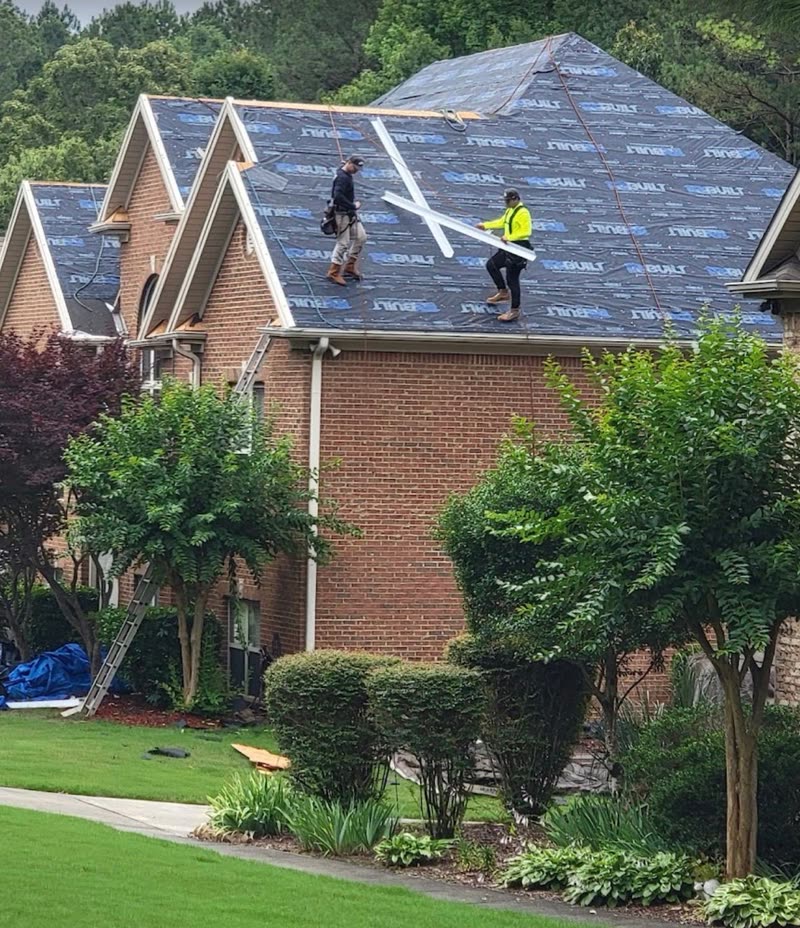 Synthetic underlayment down over the gables of a brick home mid replacement