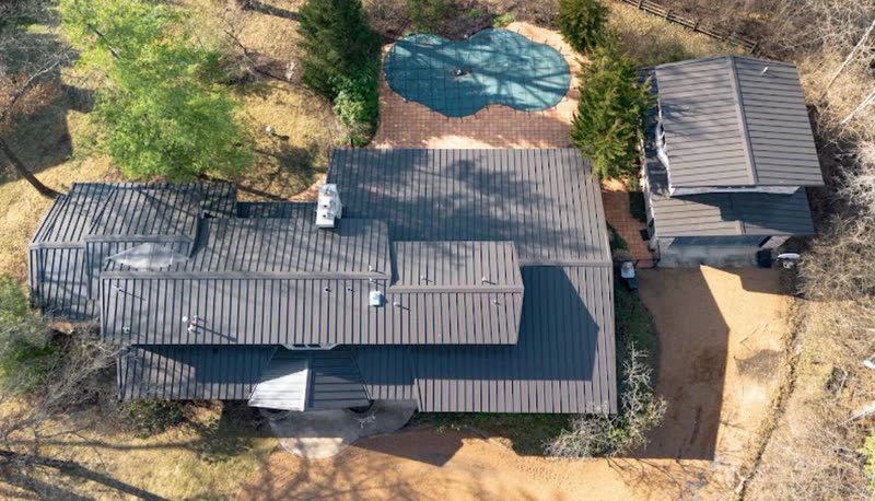 Overhead view of standing seam metal panels across the main roof and attached wing
